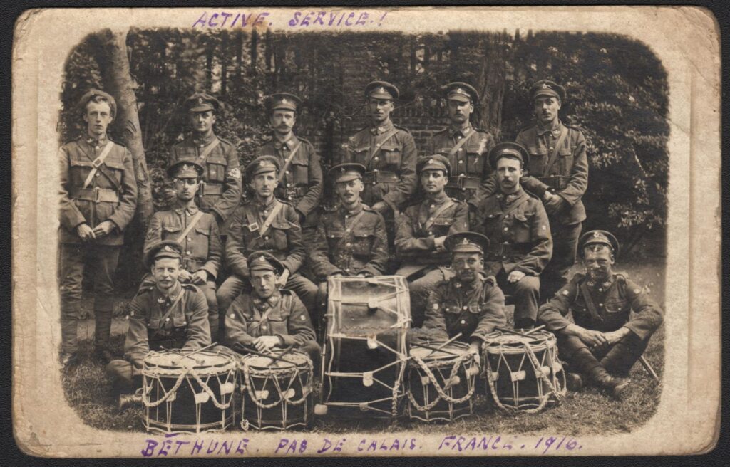 Hertfordshire Regiment drum corps, Bethune, Pas De Calais, France 1916. Bugler Hills back row far left